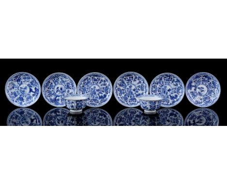2 porcelain cups and 6 saucers with blue decor of a grasshopper near a rock and surrounding it a lotus whose leaves have a di