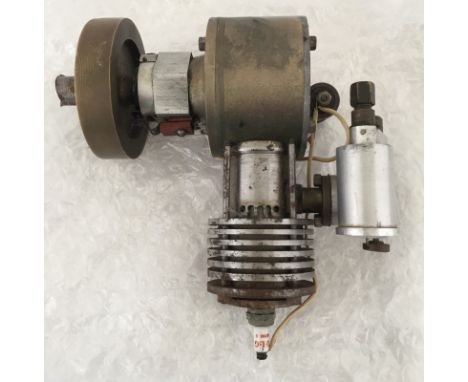 A scratch built single cylinder air-cooled spark ignition engine.  Measures approx 16 x 16 x 8cm.