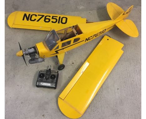 A large remote control scratch built plane. Wooden construction, petrol driven engine with controller. Vendor advises batteri