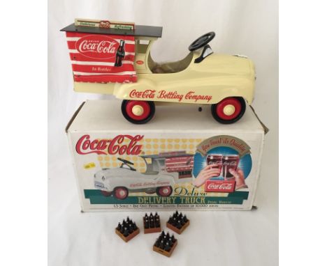 A boxed Coca-Cola deluxe pedal delivery truck. Diecast limited edition.  36cm long,1:3 scale.