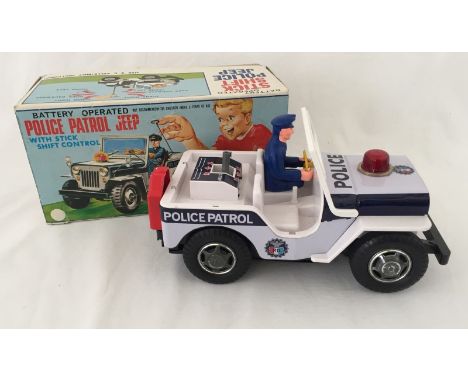 A boxed TN Toys Japan battery operated stick shift control Police Patrol Jeep.  