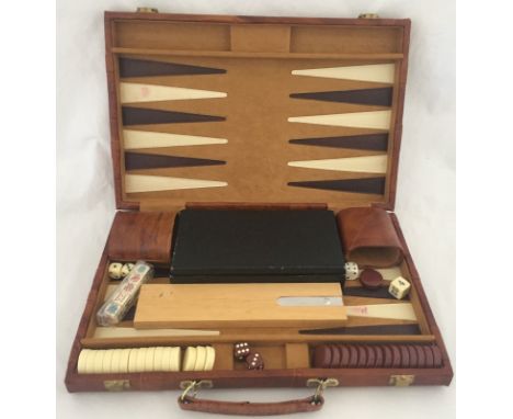 A vintage cased backgammon set together with a boxed set of dominoes and a wooden crib board.  