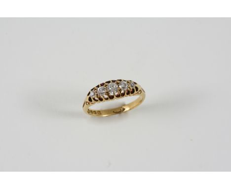 A DIAMOND FIVE STONE RING set with five graduated old brilliant-cut diamonds, in 18ct. gold. Size M.