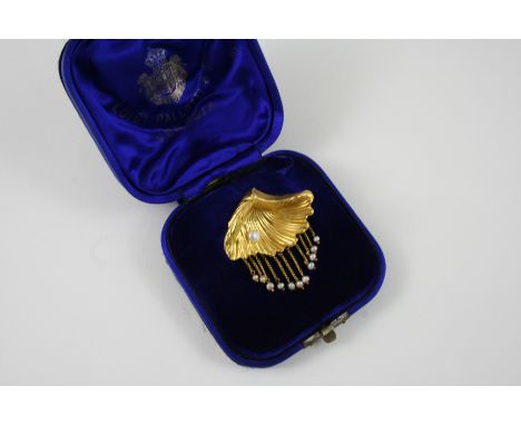 A GOLD AND PEARL SET SHELL BROOCH the gold shell is realistically formed, mounted with a small pearl, with gold chain and pea