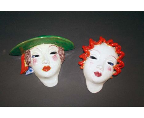 ART DECO TERRACOTTA FACE MASKS two terracotta masks of ladies, one mask with a green hat and the other with curly hair. Both 
