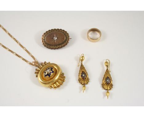A VICTORIAN GOLD LOCKET PENDANT centred with a half pearl within blue enamel star decoration, vacant locket compartment to th