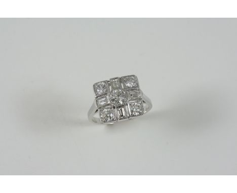 AN ART DECO STYLE DIAMOND CLUSTER RING centred with a circular-cut diamond within a surround of four circular and four baguet