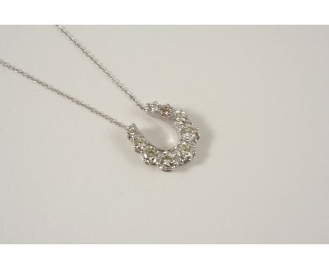 A DIAMOND HORSESHOE PENDANT set with graduated circular-cut diamonds weighing approximately 2.0 carats in total, on an 18ct. 