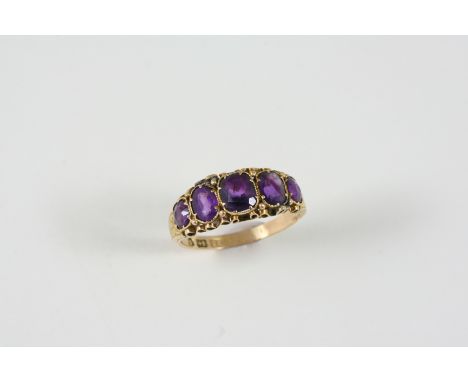 A VICTORIAN AMETHYST FIVE STONE RING the five graduated oval-shaped amethysts are set in 15ct. gold. Size M 1/2.