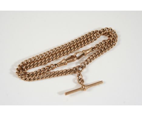 A 9CT. GOLD CURB LINK WATCH CHAIN suspending a 9ct. gold 't' bar, 36cm. long, 28 grams.