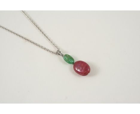 A RUBY, EMERALD AND DIAMOND PENDANT set with a ruby and emerald oval drop, with rose-cut diamonds set to the bale, on a plati