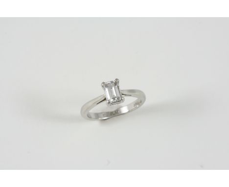 A DIAMOND SOLITAIRE RING the emerald-cut diamond weighs approximately 0.75 carats and is set in platinum. Size L.