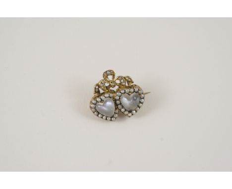 A MOONSTONE AND PEARL SET DOUBLE HEART BROOCH the two heart-shaped moonstones are set within a surround of small pearls, in s