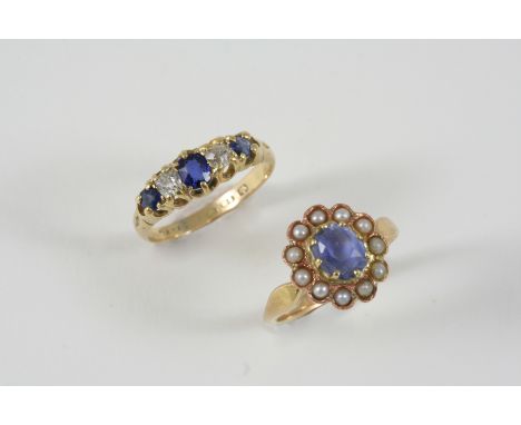 A SAPPHIRE AND DIAMOND FIVE STONE RING the central oval-shaped sapphire is set with two circular-cut sapphires and two old br