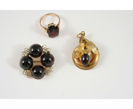 A GEORGIAN GARNET AND GOLD BROOCH set with four circular cabochon garnets in gold closed back settings, 3cm. wide, together w