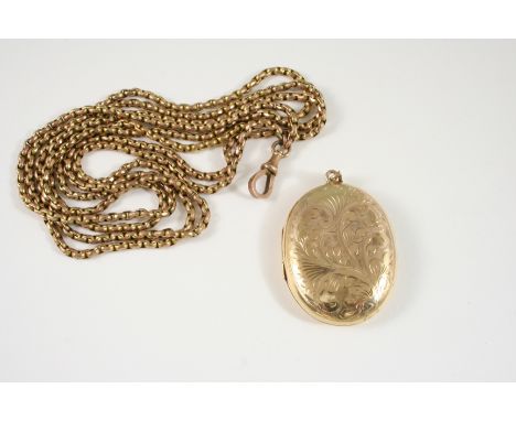 A 9CT. GOLD OVAL SHAPED LOCKET PENDANT with foliate engraved decoration to the front case, 4.5 x 3.5cm., 12 grams, together w