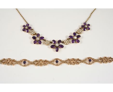 AN AMETHYST AND PEARL NECKLACE formed with graduated flowerheads each set with oval-shaped amethysts and centred with a half 