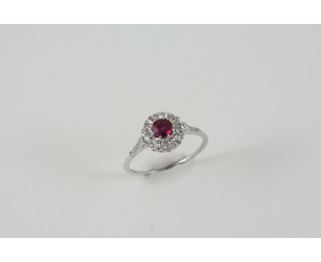 A RUBY AND DIAMOND CLUSTER RING the circular-cut ruby is set within a surround of circular-cut diamonds, with rose-cut diamon