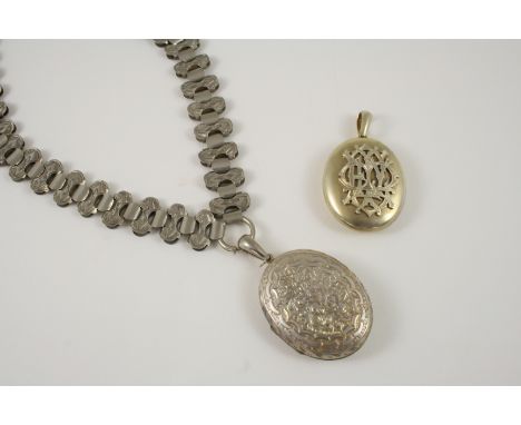 A VICTORIAN METAL PENDANT AND CHAIN  with engraved decoration, together with another locket pendant embossed with initials.
