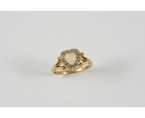 AN OPAL AND DIAMOND HEART-SHAPED CLUSTER RING the heart-shaped solid white opal is set within a surround of rose-cut diamonds