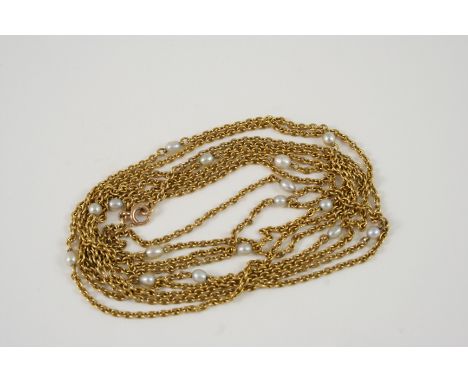AN 18CT. GOLD LONG GUARD CHAIN mounted with small pearls, 146cm. long, 27 grams.