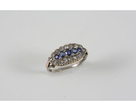 A SAPPHIRE AND DIAMOND CLUSTER RING centred with a row of five graduated sapphires within a surround of old brilliant-cut dia