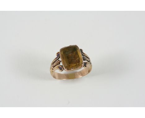 A GEORGIAN CITRINE AND GOLD RING mounted with a rectangular citrine in gold closed back setting and inscribed Mary. Size K.