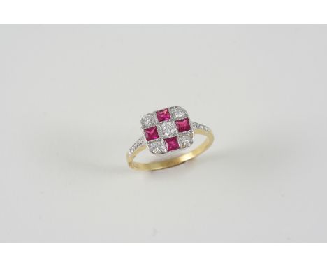 A RUBY AND DIAMOND CHEQUERBOARD DESIGN RING set with square-shaped rubies and circular-cut diamonds, in 18ct. gold. Size L 1/