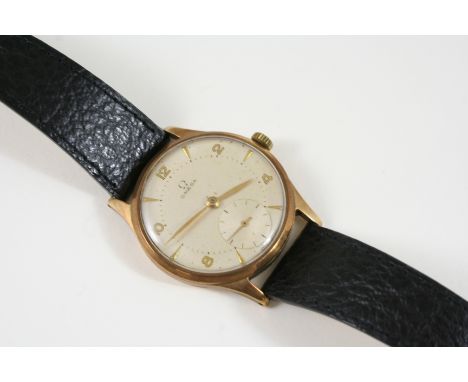 A GENTLEMAN'S GOLD WRISTWATCH BY OMEGA the signed circular dial with Arabic and dagger numerals, with subsidiary seconds dial