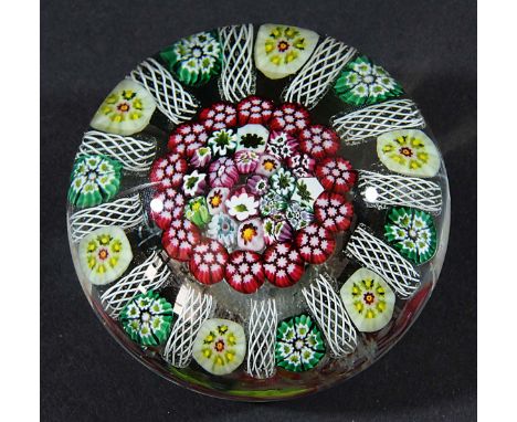 CONTINENTAL GLASS PAPERWEIGHT, possibly Italian, a central cluster of canes inside a ring of red canes, latticino, cream and 