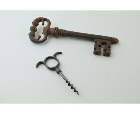 A vintage novelty 'Corkscrew Key'. Key head unscrews to reveal a corkscrew in key shaft. Cast iron body with steel corkscrew,
