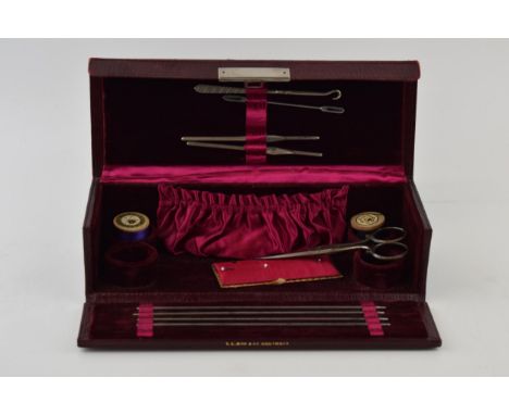 Vintage read leather cased sewing box to include fitted interior with sewing accessories and tools.