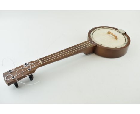 A vintage Banjolele / Ukulele. Wooden neck and wooden body. Length 53cm.