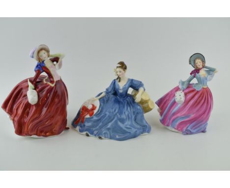 Royal Doulton figures 'Autumn Breezes' H.N. 4716, 'Autumn Breezes' H.N. 1934 and 'Elyse' H.N. 2429. Height 19cm. (3) Of first