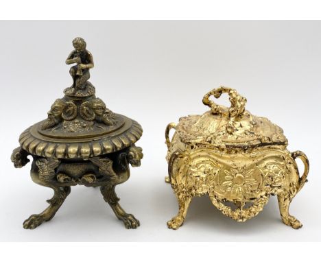A finely cast 19th century brass inkwell with winged griffin feet and a faun playing a pipe, and a gold leafed bronze box wit