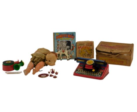 A group of toys, to include a Mettype Junior tinplate typewriter, boxed, a mid century doll, (AF), Moko painted cast metal Mu