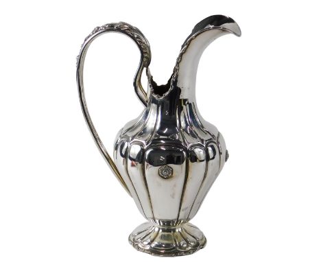 A Peruvian white metal jug or ewer, with shaped body, leaf cast pierced handle, and domed foot, stamped 925 Peru, 22.81oz, 30