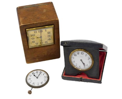 A travelling clock, the dial stamped John Bull &amp; Co Bedford, in leather case, a travelling clock fitted into a later maho