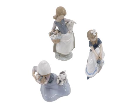 A Lladro figurine of a young girl, carrying a basket and a lamb, another figure of a seated girl with a Dalmation and a cat, 
