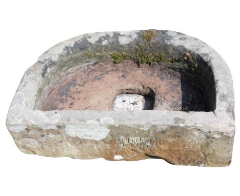 A half moon shaped sandstone trough or planter, 22cm high, 70cm wide, 42cm deep.