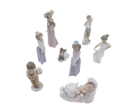 A collection of Spanish Nao porcelain figurines, to include two matching figures of a girl in a blue hat and skirt, a figure 