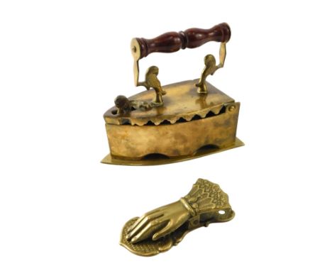 A Victorian style brass and turned wooden flat iron, and a hand shaped letter clamp. (2)