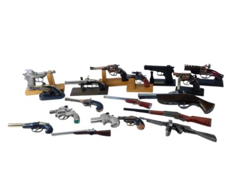 A quantity of novelty lighters, each relating to a firearm, to include pistols, machine gun, etc.