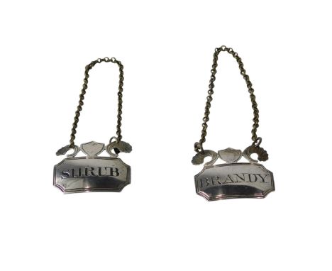 A pair of George III small silver decanter labels, each decorated with a shield flanked by scrolls, for Shrub & Brandy, Londo