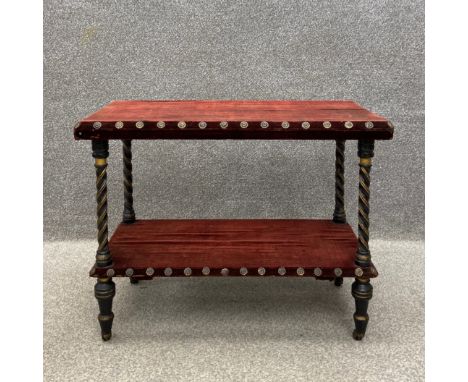 A late 19th century two tier buffet having a square top with a bevelled edge covered in an oxblood velvet and flowerhead stud