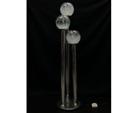 A 1970's Italian floor lamp having three moulded spherical (possibly Murano) glass shades raised on three stepped cylindrical