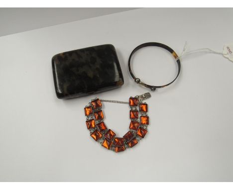 A tortoiseshell bangle with ball terminals, a foil back link bracelet and a faux tortoiseshell cigarette box 