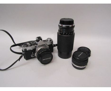 An Olympus OM-2n camera with 70-210mm lens, 1:28 lens and instruction manuals 