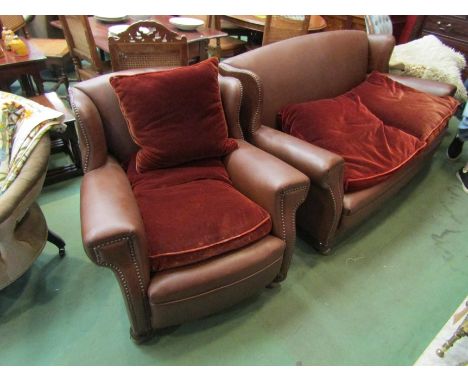 A brown leatherette sofa with two armchairs 