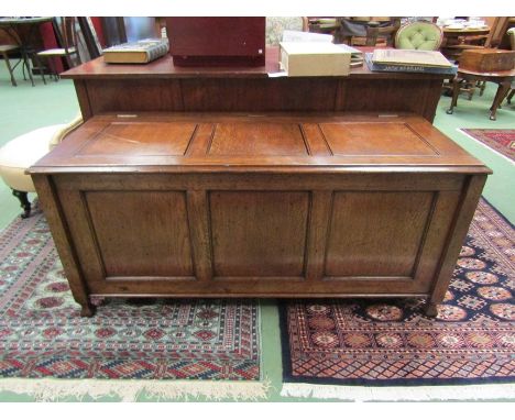 An 18th Century style three panel oak coffer in the manner of 'Titchmarsh &amp; Goodwin' the hinged top over shaped feet. 60c